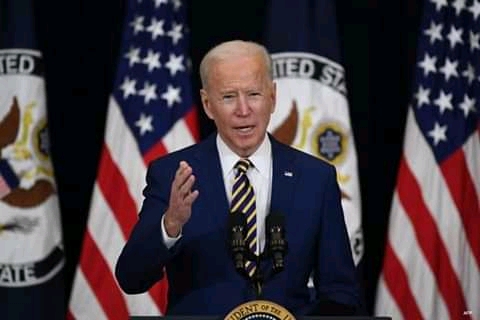 President Joe Biden speaks to staff